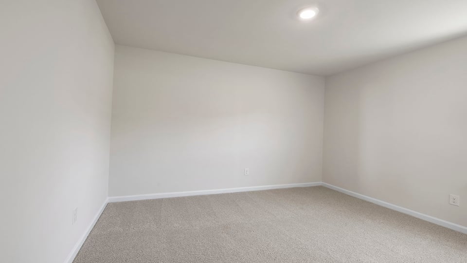 Bedroom with carpet and window.
