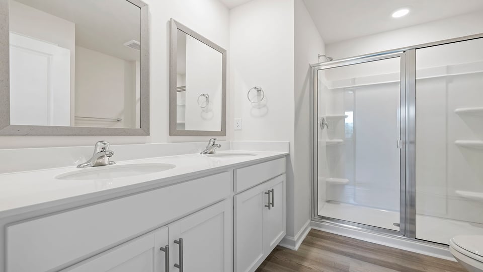 Bathroom with vanity and shower.