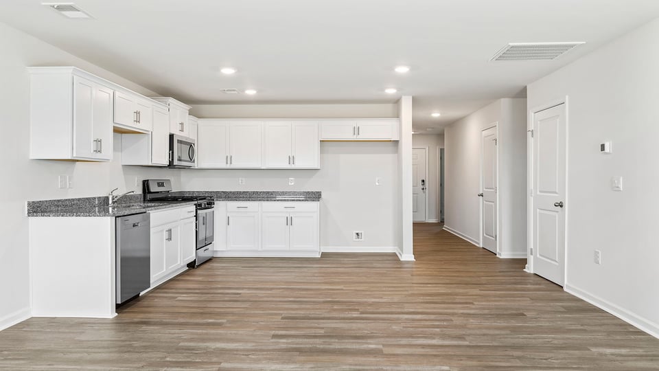 Kitchen with quartz countertops and stainless steel appliances.