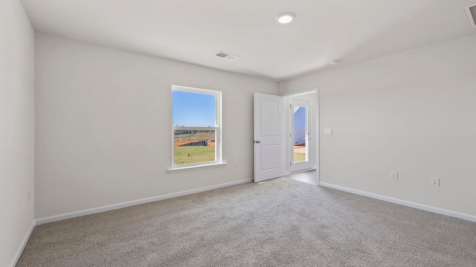 Bedroom with carpet and window.