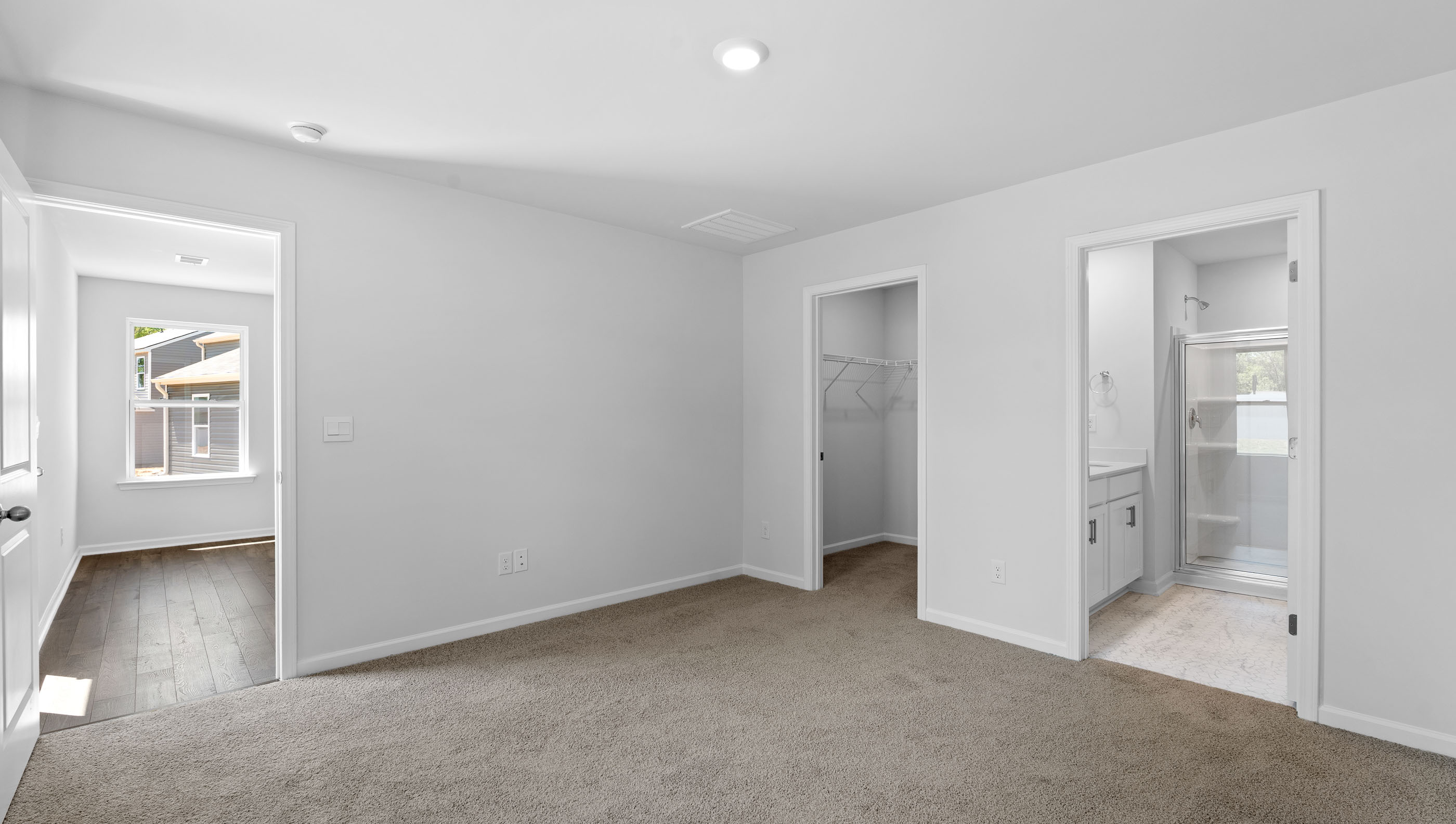 Bedroom with carpet and window.a