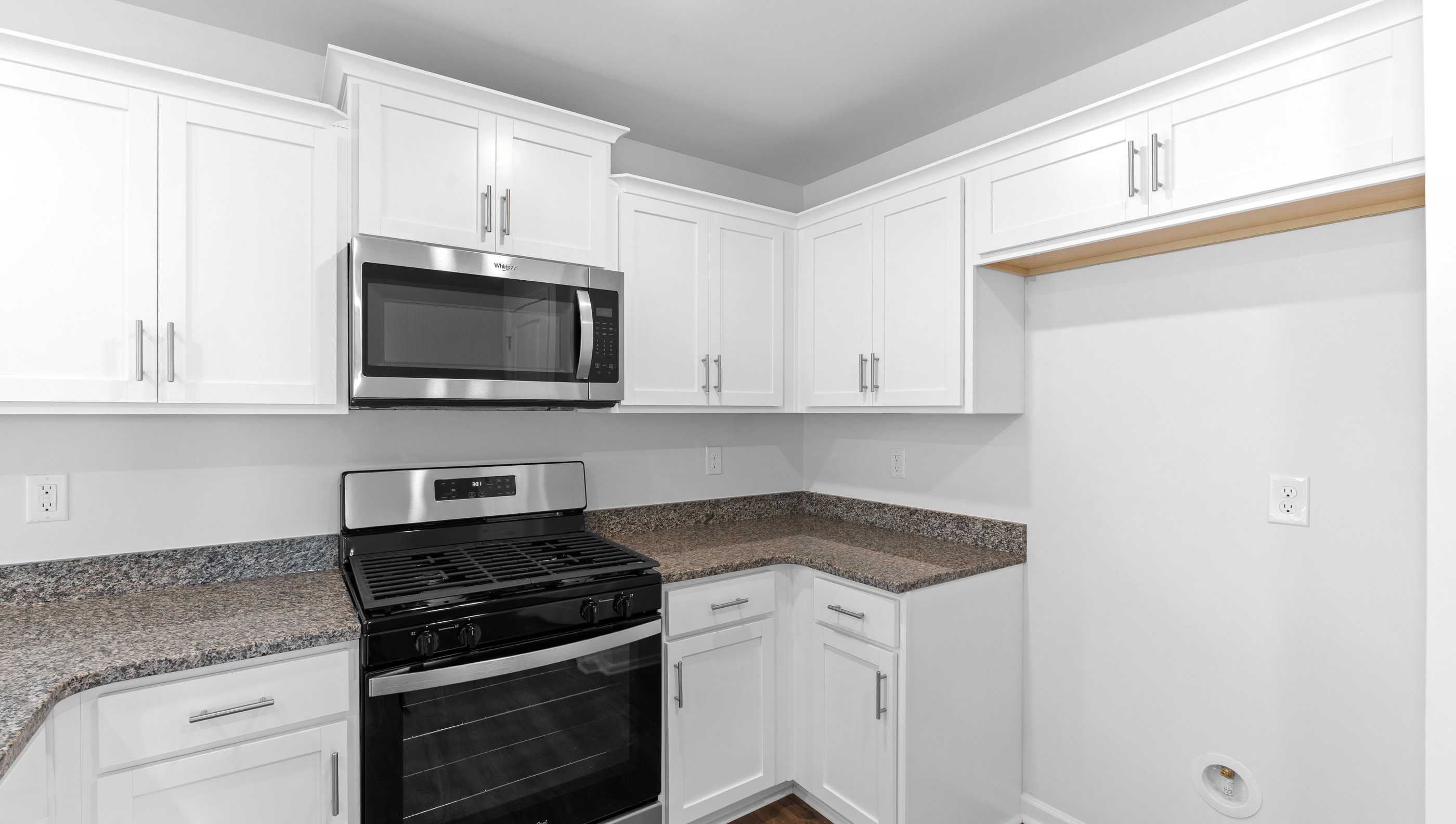 Kitchen with granite counter tops and stainless steel appliances.