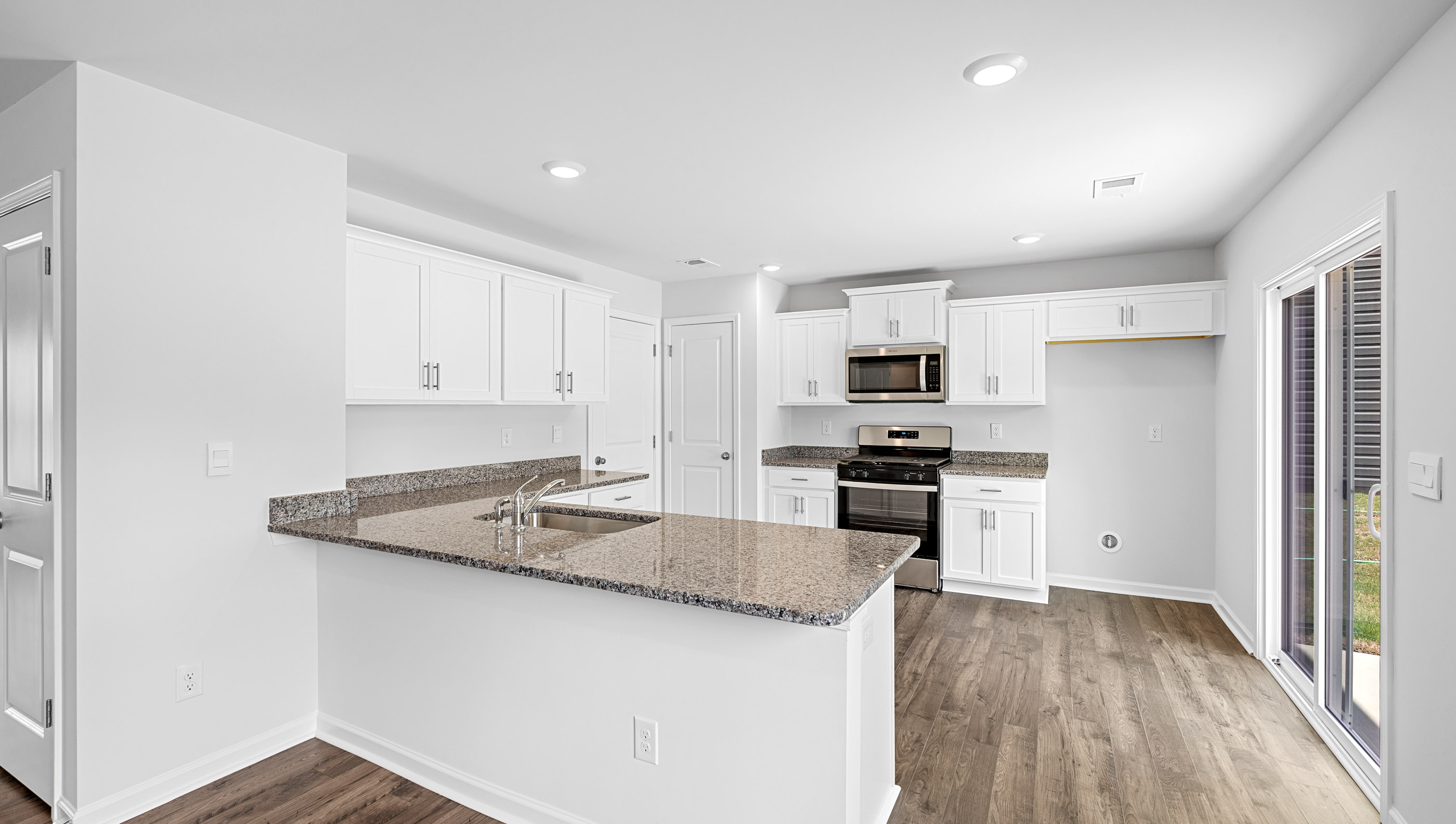 Kitchen with granite countertops and stainless steel appliances.