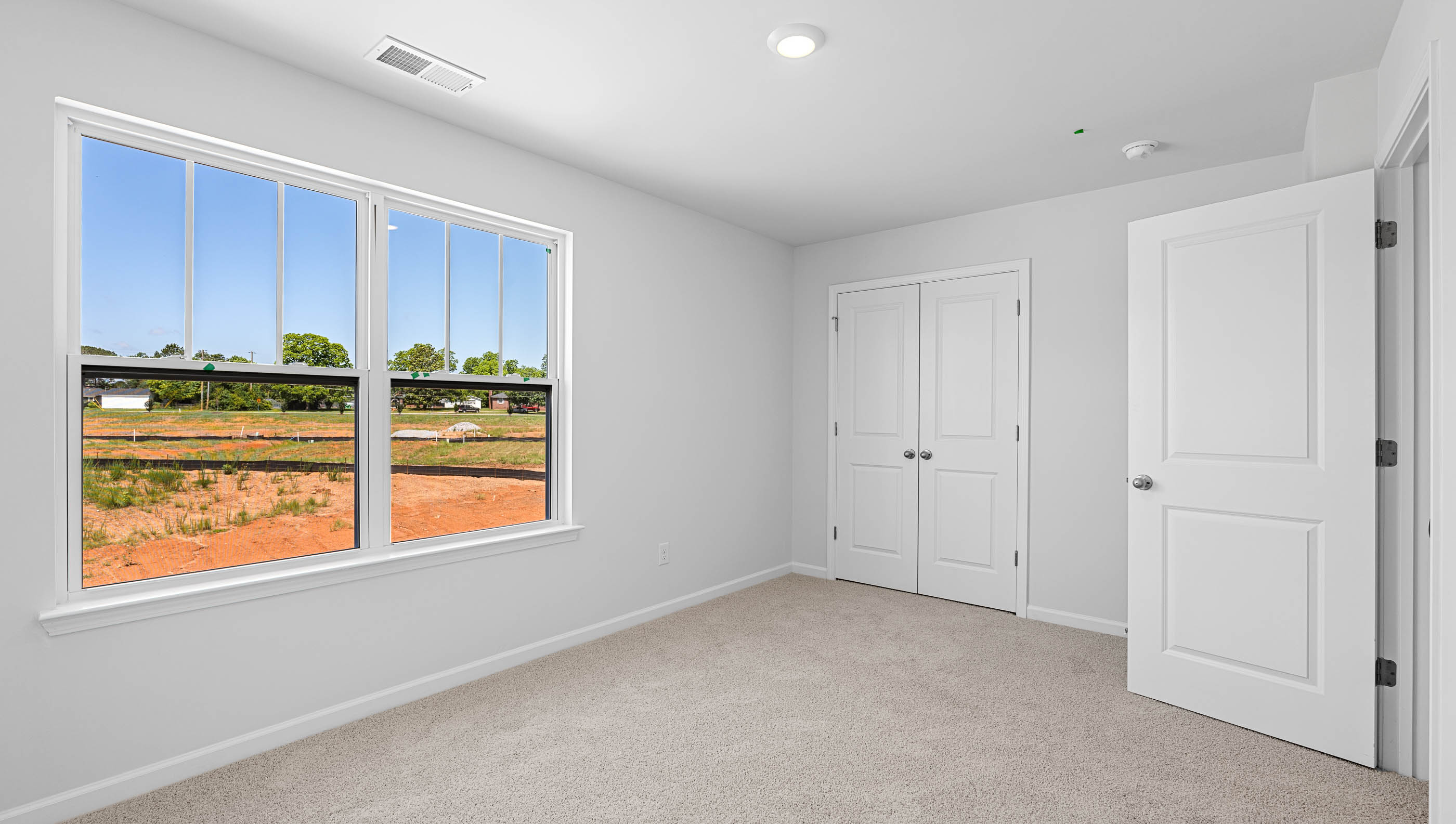 Bedroom with carpet and window.