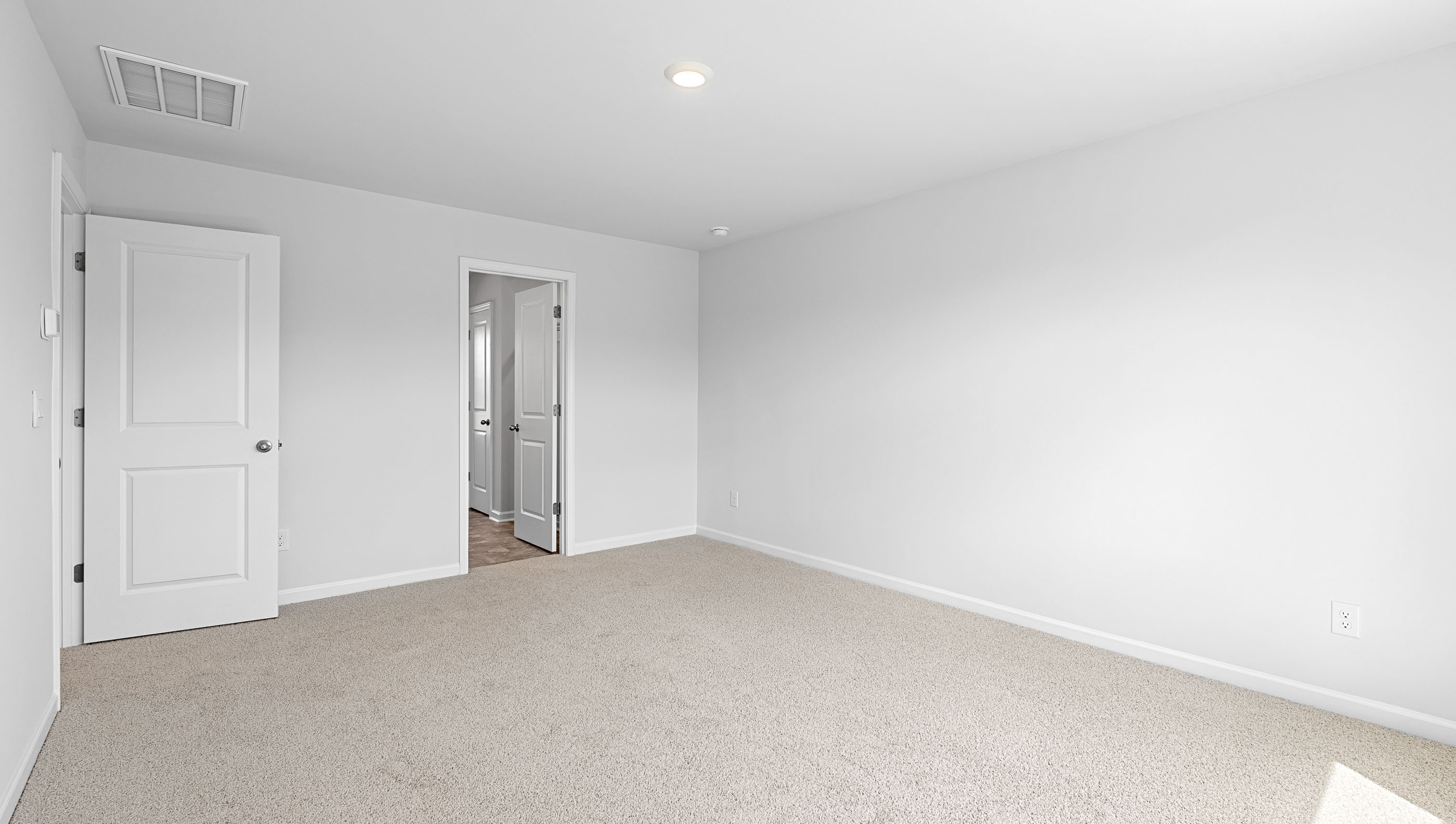 Bedroom with carpet and window.