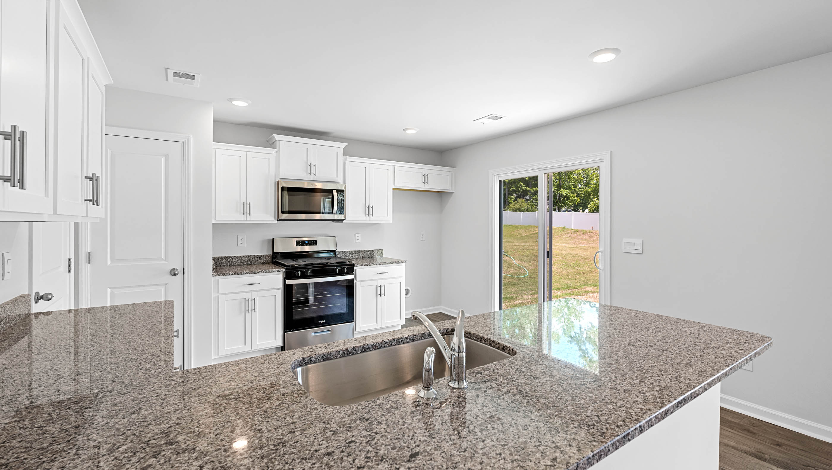 Kitchen and peninsula with granite countertops.