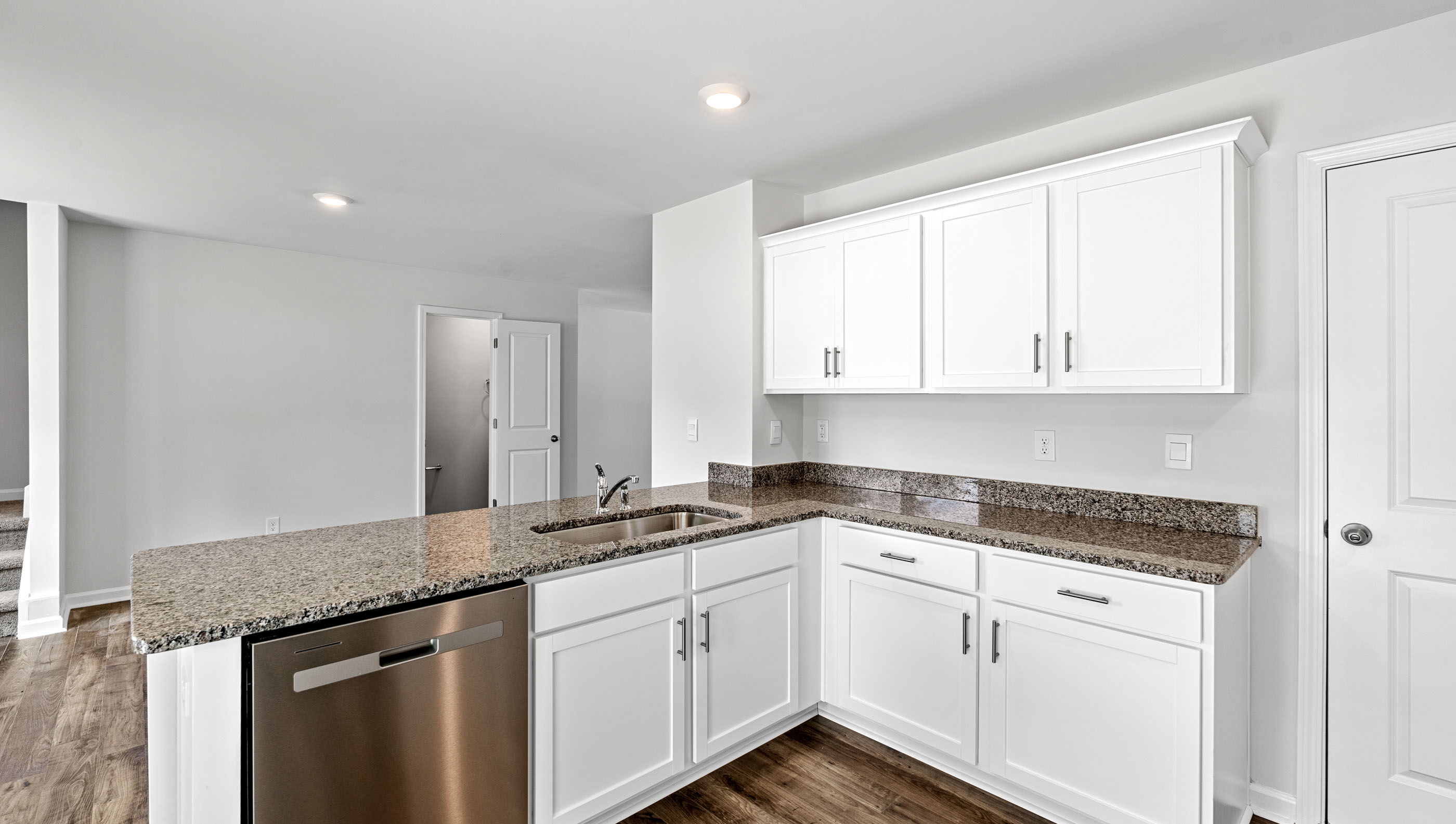 Kitchen and peninsula with granite countertops.