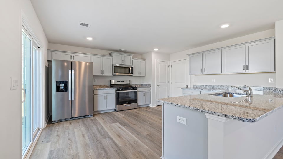 Kitchen with granite countertops and stainless steel appliances.