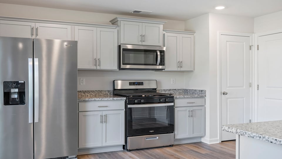 Kitchen with granite countertops and stainless steel appliances.