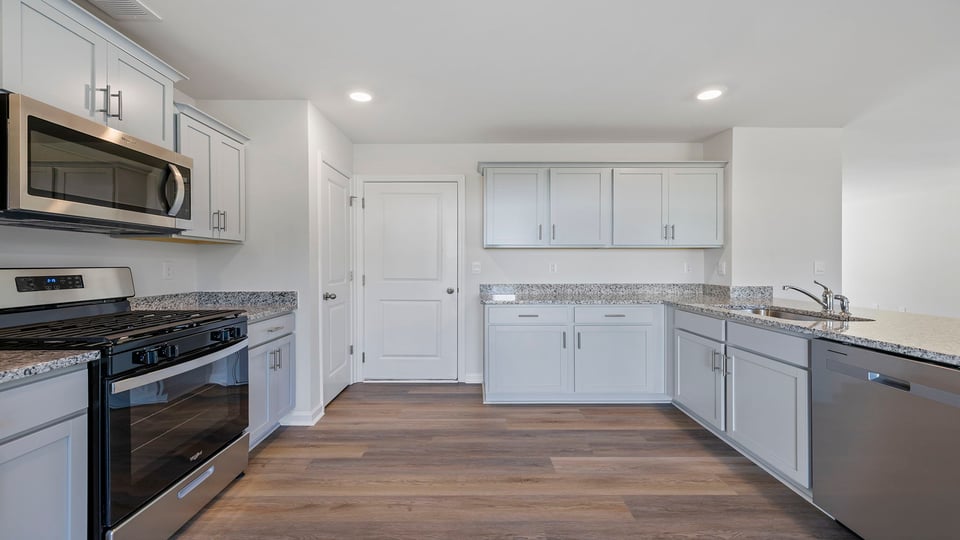Kitchen with granite countertops and stainless steel appliances.
