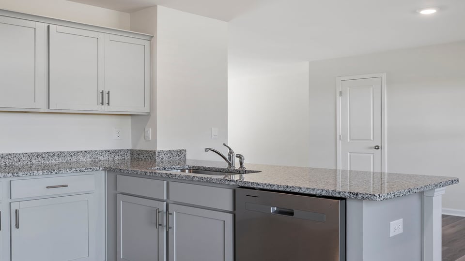 Kitchen with granite countertops and stainless steel appliances.