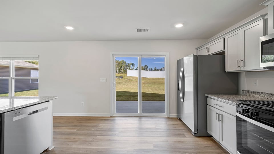 Kitchen with granite countertops and stainless steel appliances.