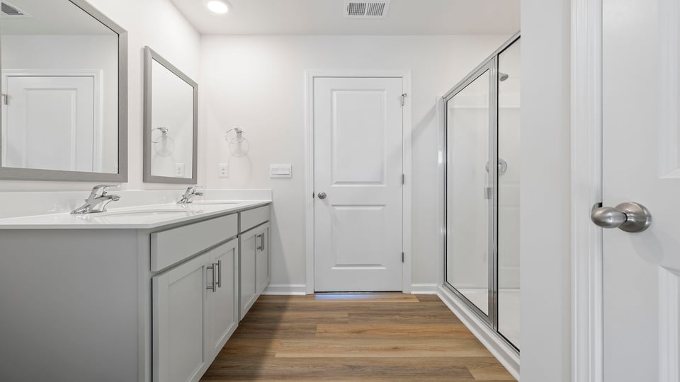 Bathroom with vanity and walk in shower.
