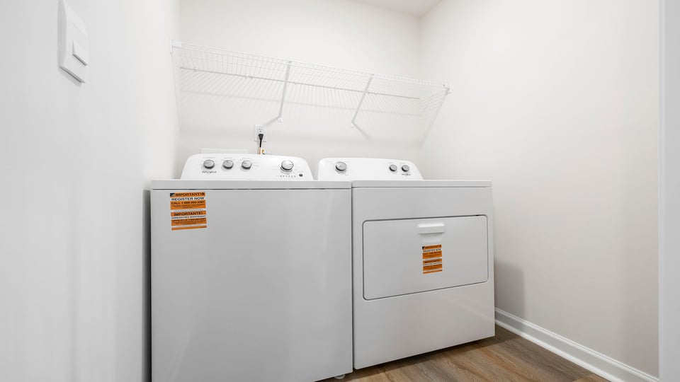 Walk in laundry with hanging shelves.