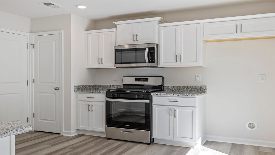 Kitchen with granite countertops and stainless steel appliances.