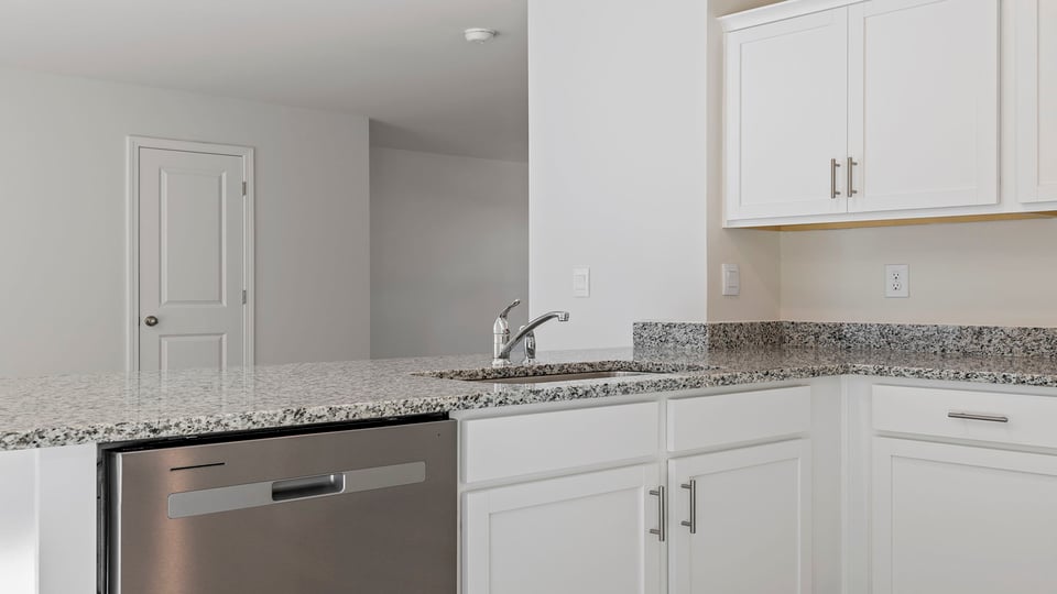 Kitchen with granite countertops and stainless steel appliances.