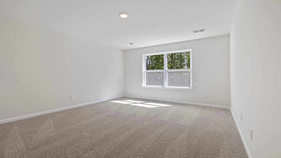 Bedroom with carpet and window.