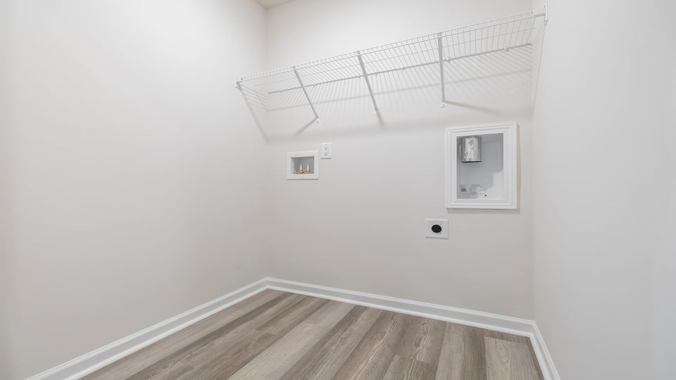 Walk in laundry with shelves.