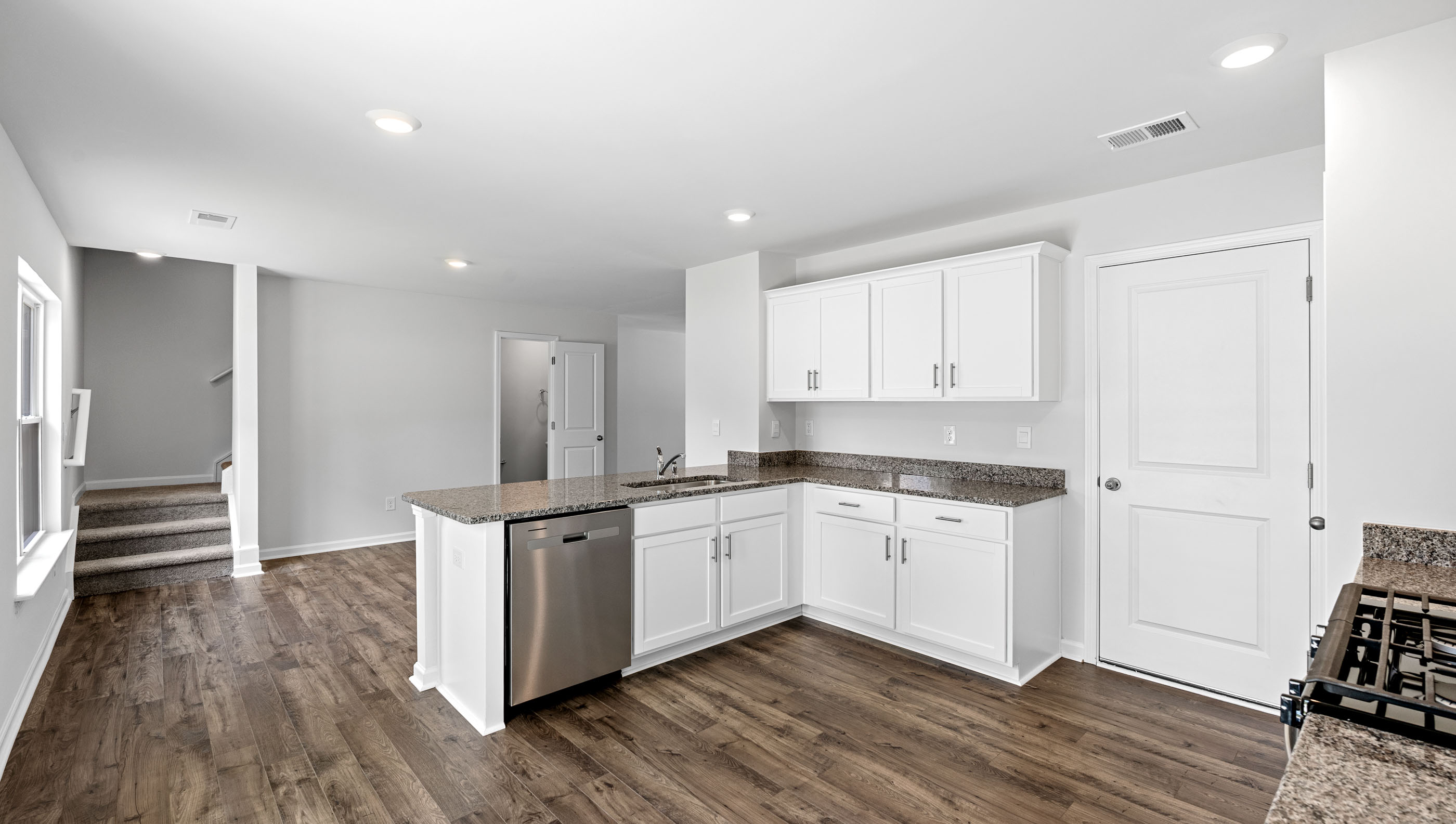 Kitchen with granite countertops and stainless steel appliances.