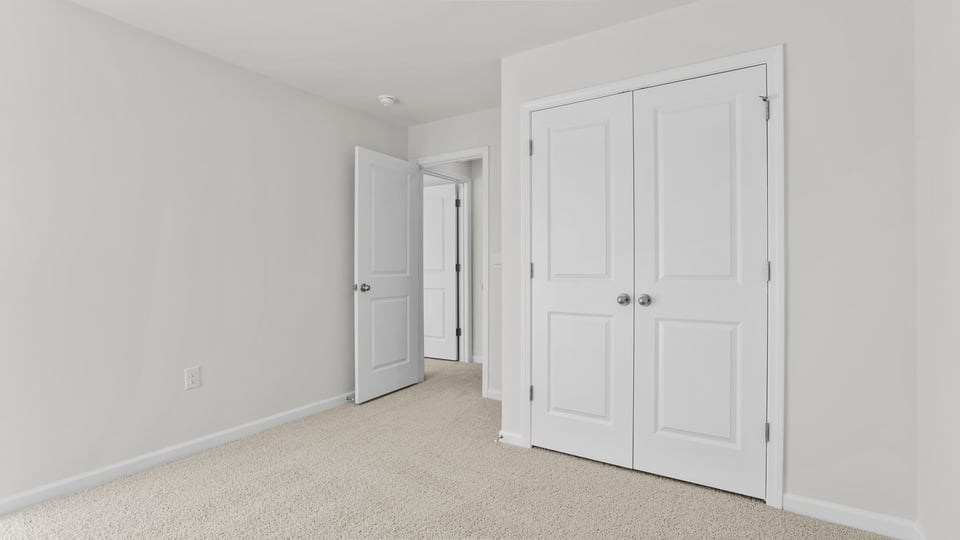 Bedroom with carpet and window.