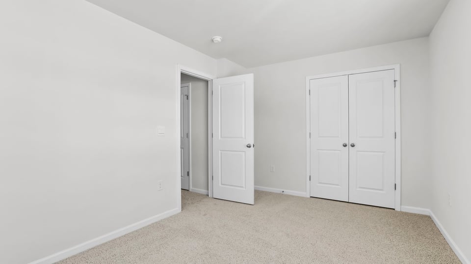 Bedroom with carpet and window.