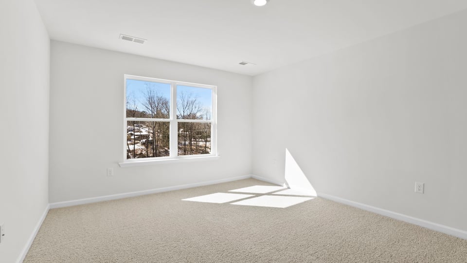 Bedroom with carpet and window.