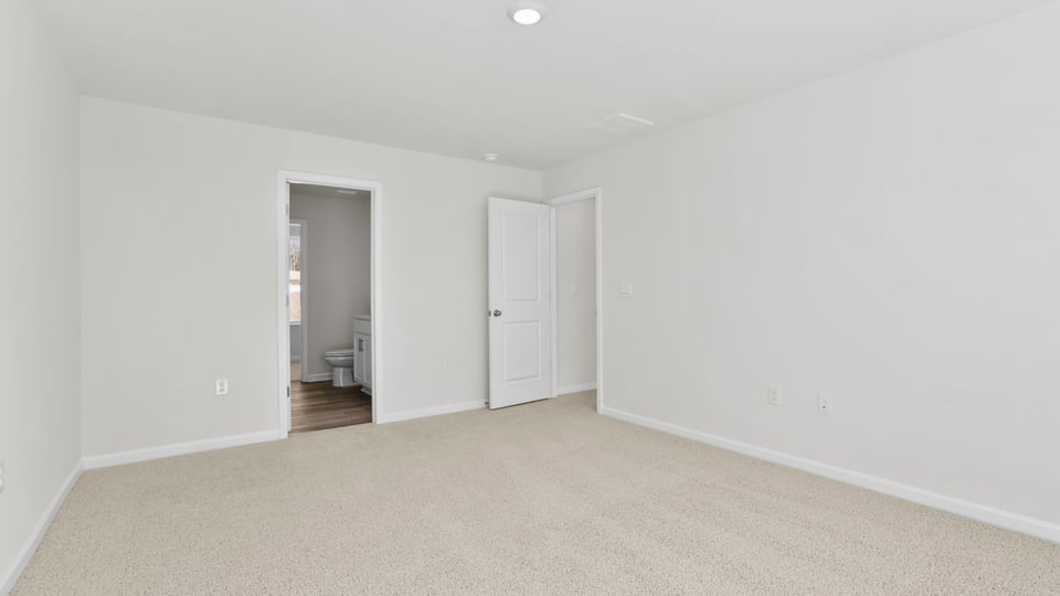 Bedroom with carpet and window.
