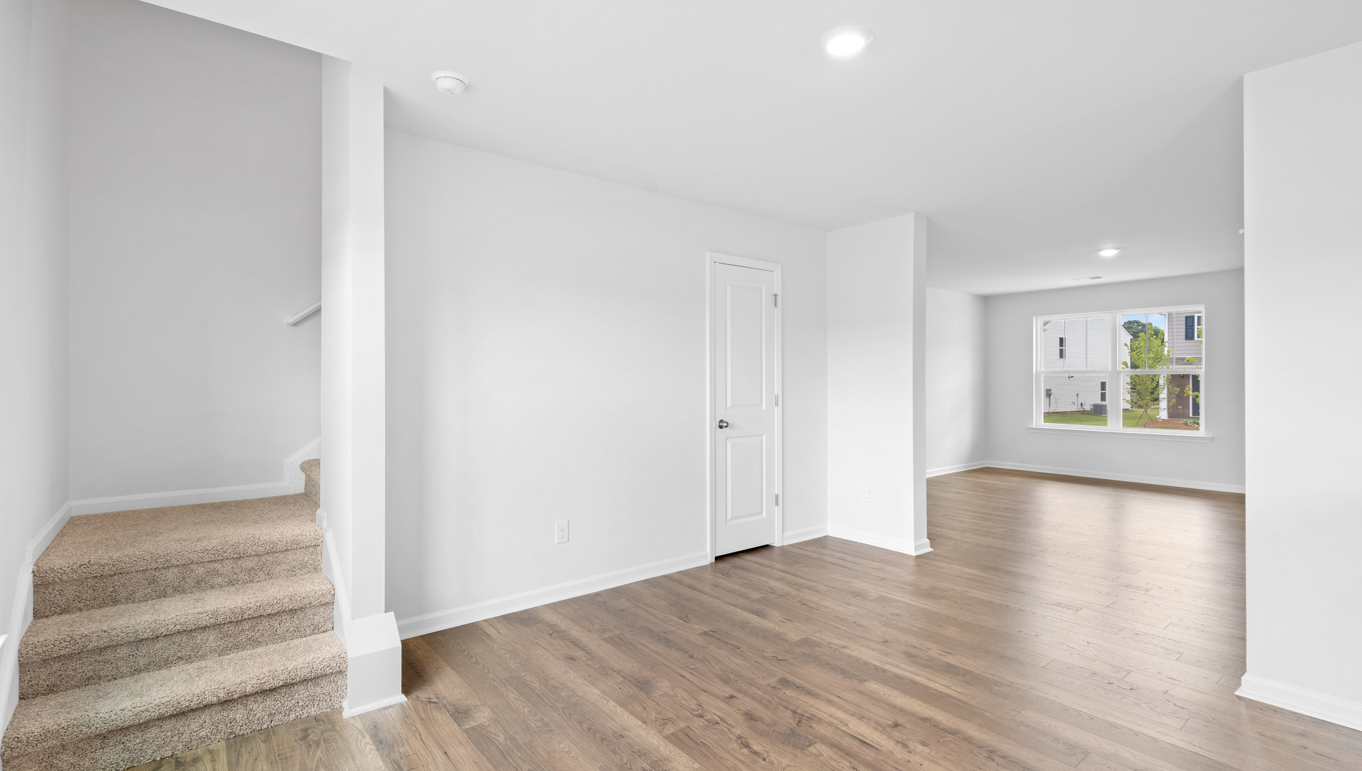Dining room with staircase to upstairs.