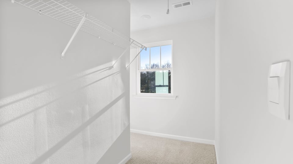 Bedroom with carpet and window.