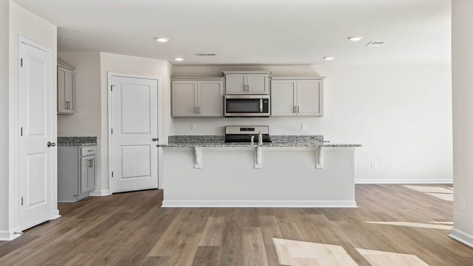 Kitchen with island and granite countertops.