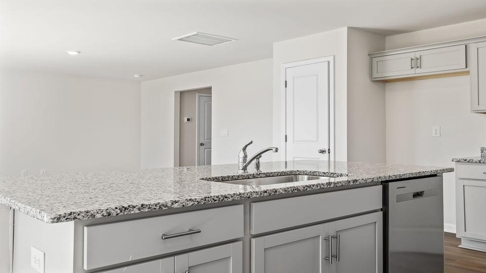 Kitchen with island and granite countertops.
