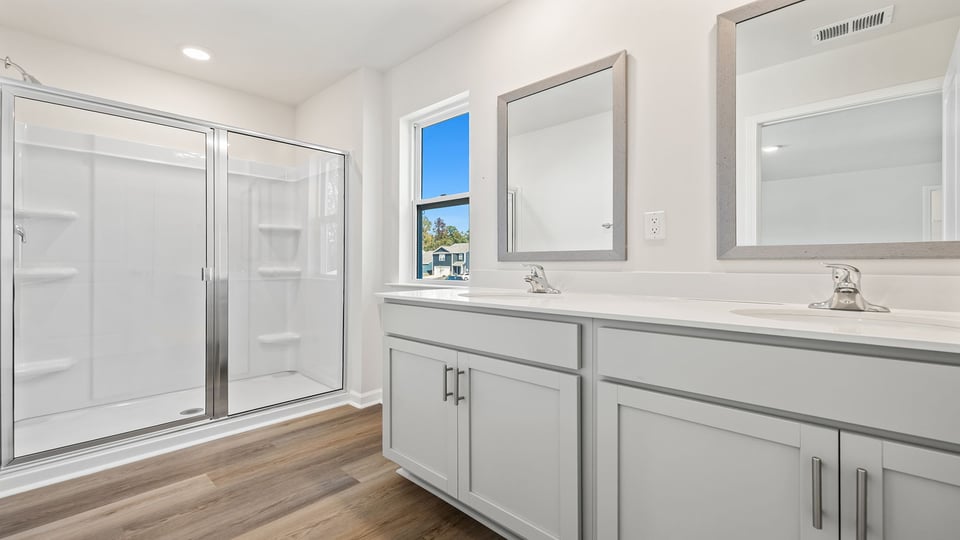 Bathroom with vanity and walk in shower.