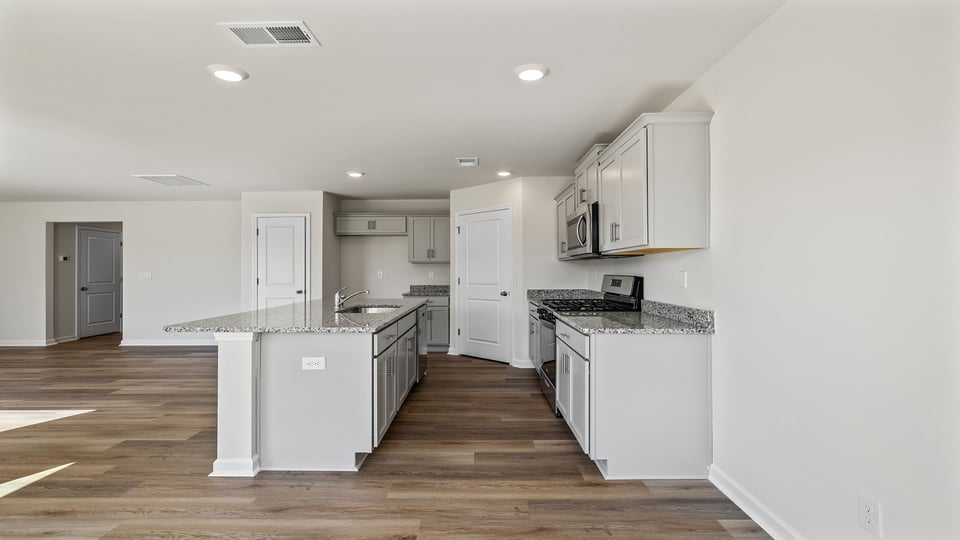 Kitchen with island and granite countertops.