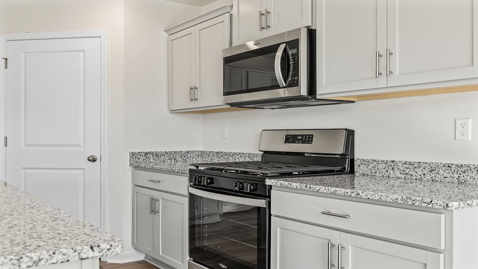 Kitchen and granite countertops and stainless steel appliances.