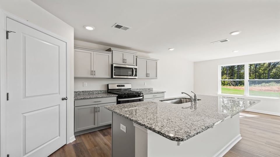 Kitchen with island and granite countertops.