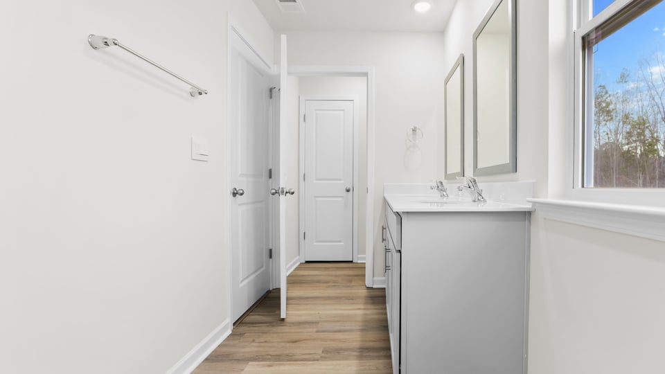 Primary bathroom with dual vanity.