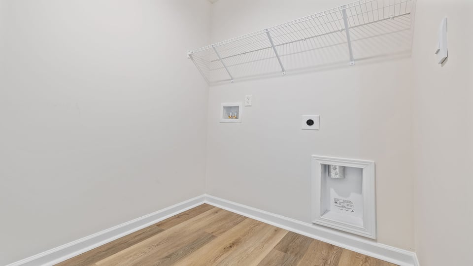 Walk in laundry with shelves.