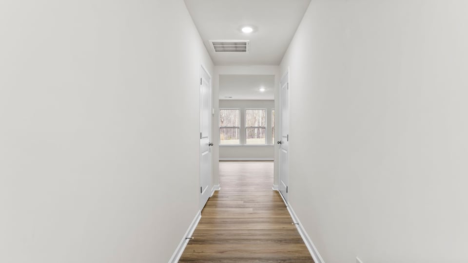 View when you enter with stairwell and hallway into the family room.