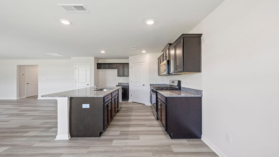 Kitchen with granite countertops and stainless steel appliances.