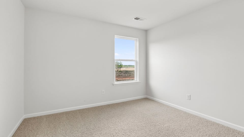 Bedroom with window and carpet.