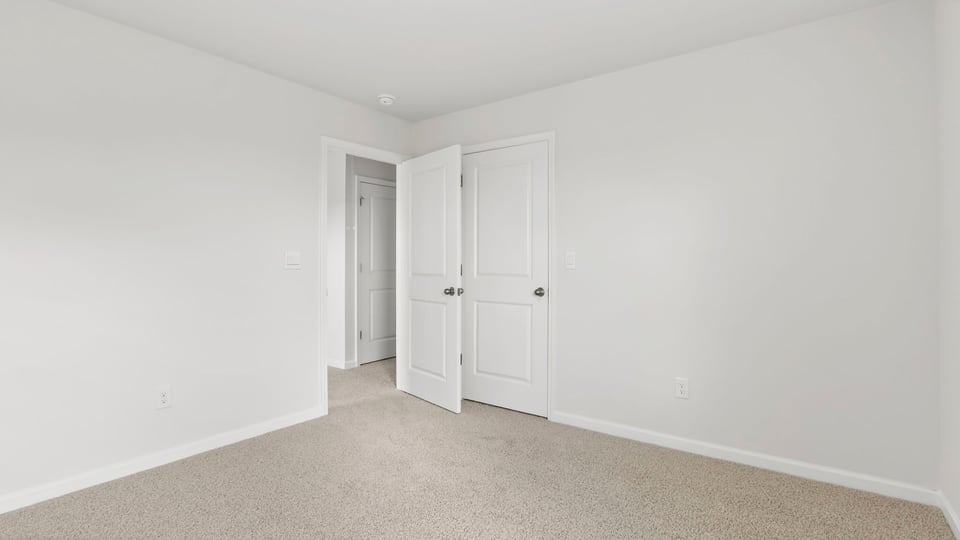 Bedroom with window and carpet.