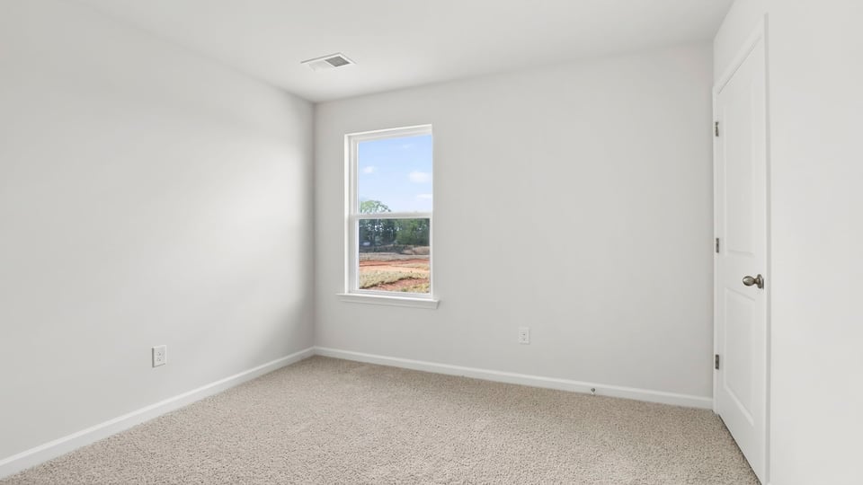 Bedroom with window and carpet.