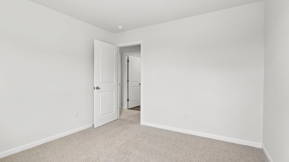 Bedroom with window and carpet.