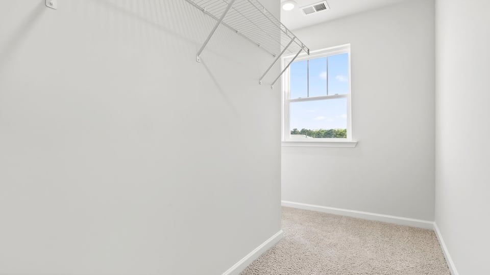 Primary bedroom walk-in closet.
