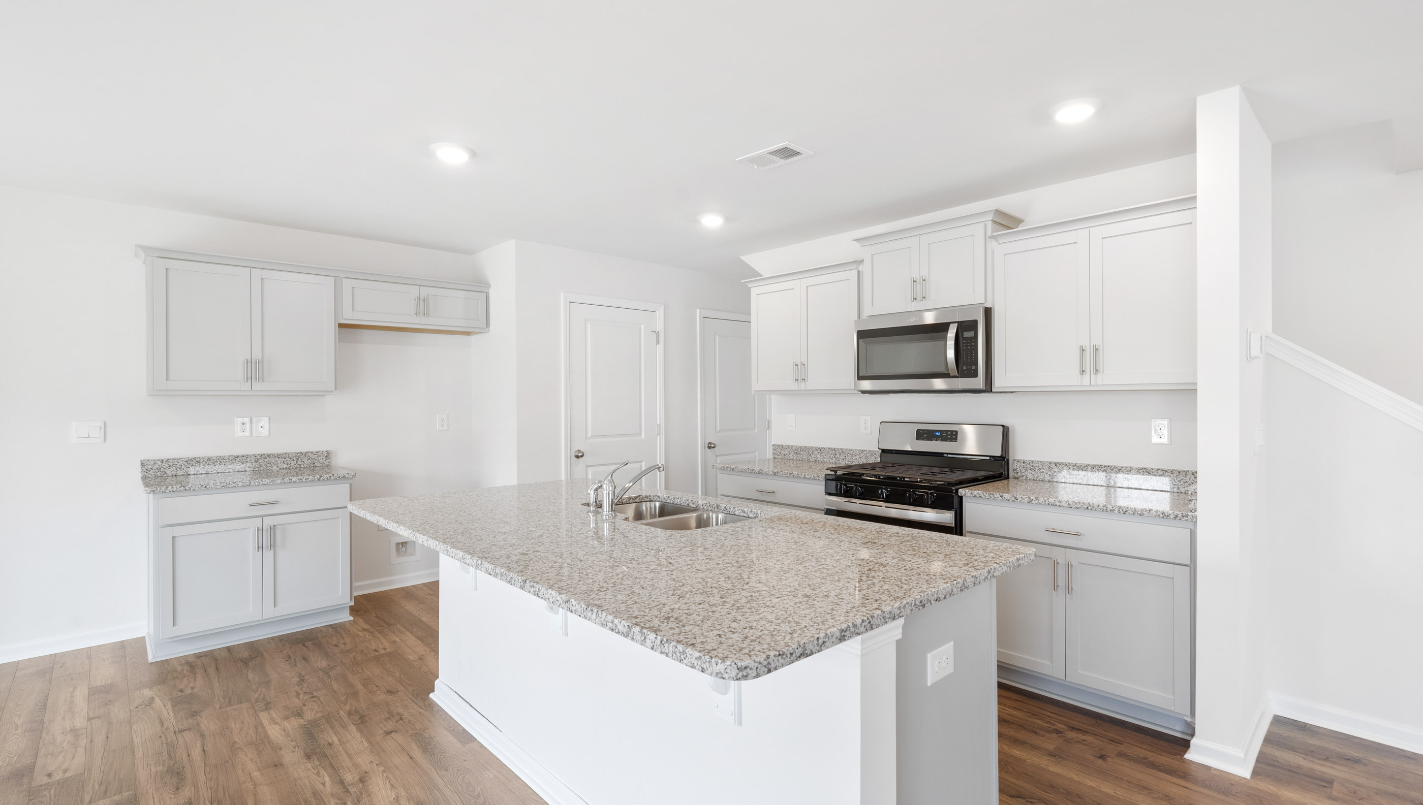 Kitchen and island with granite counter tops.