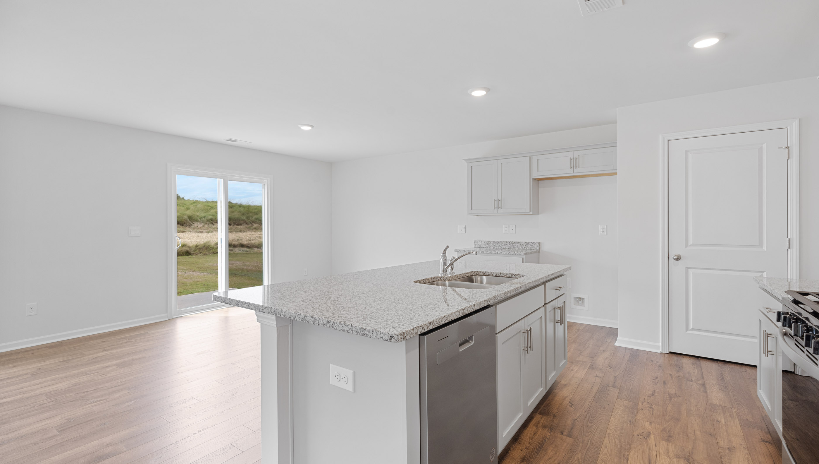 Kitchen and island with granite counter tops.