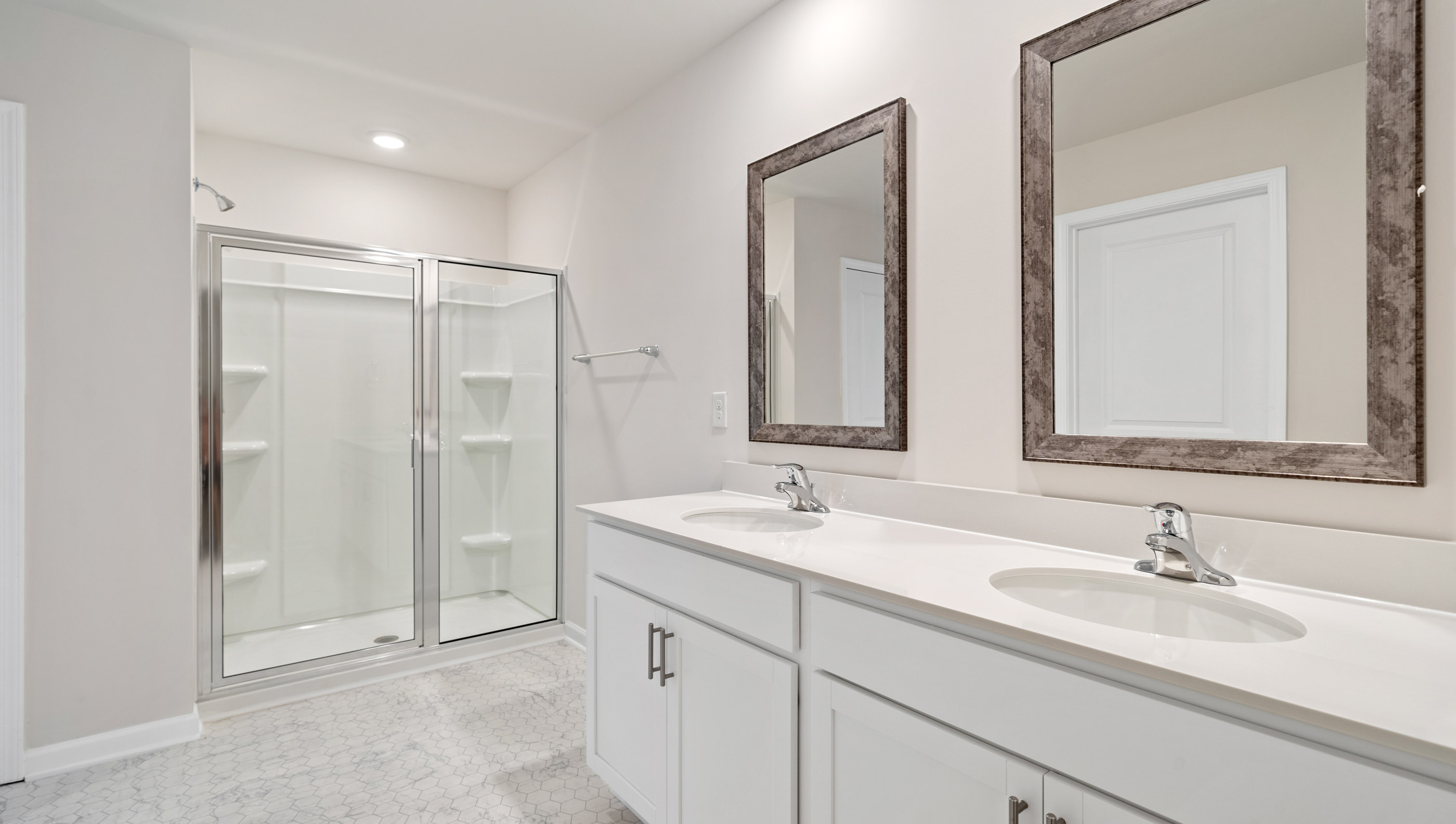 Double sink vanity with walk in shower.