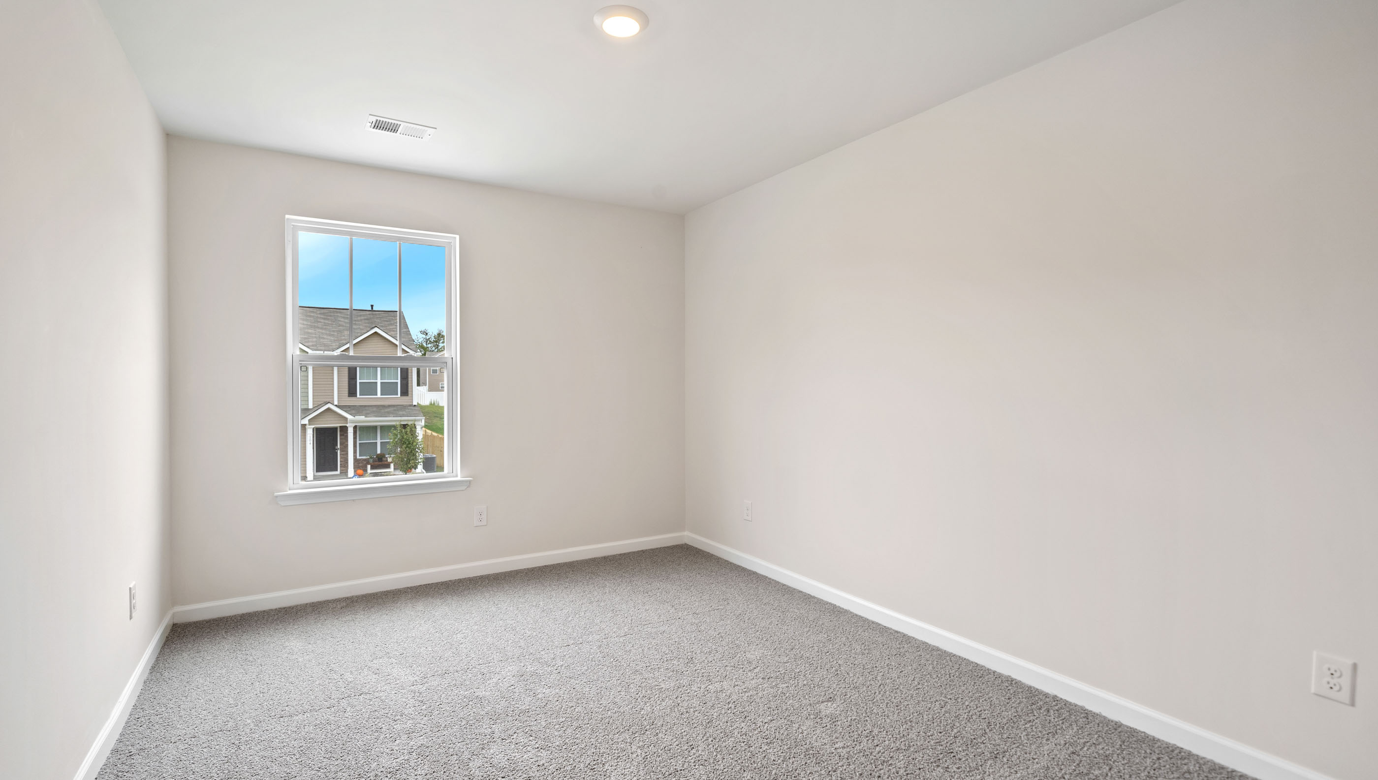 Room with carpet and large windows.
