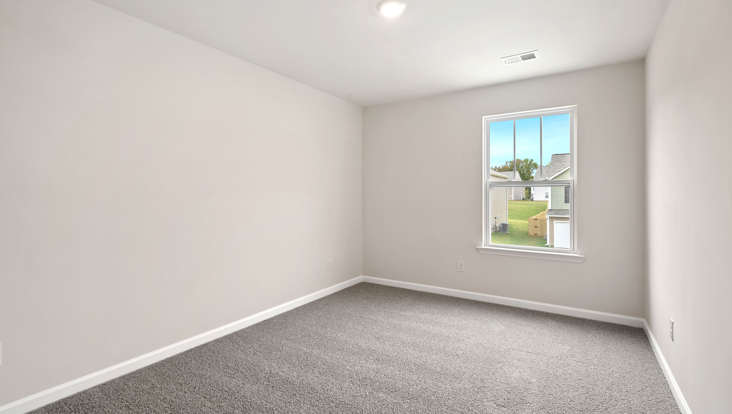 Room with carpet and large windows.