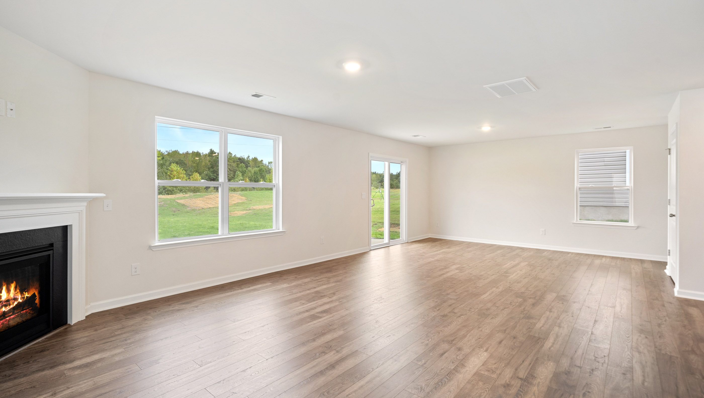 Family room with view of dining with large windows.
